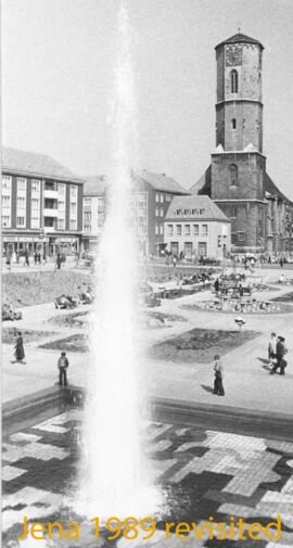 Platz der Kosmonauten um 1975, Bildautor: Winfried Haun, undatiert [um 1975]; mit Brunnen, im Hintergrund Stadtkirche (Stadtarchiv Jena, Sign. FS 15/010)